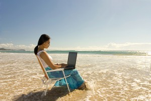 woman writing on the beach