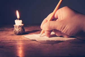writing by candlelight