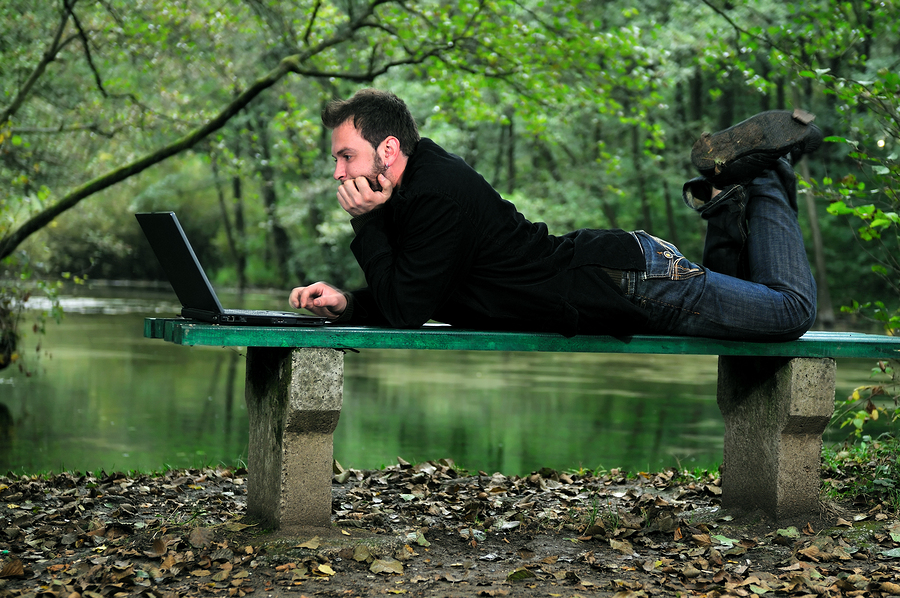 man outside on laptop setting effective goals