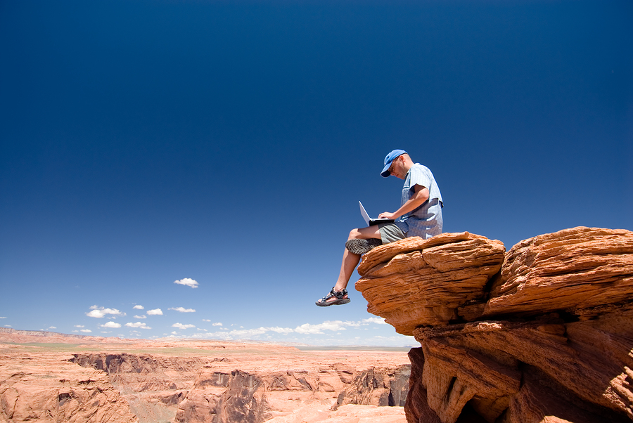 writer sitting on rock marketing his freelance website