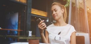 woman using a secure connection on public wi-fi on her cell phone