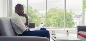 Man finding his writing niche on laptop