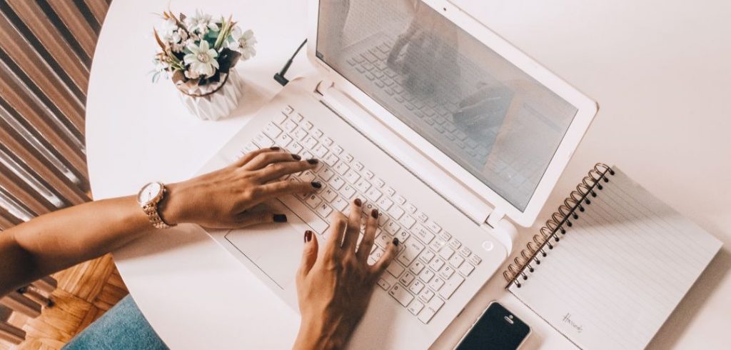 writer on laptop boosting their profile on LinkedIn