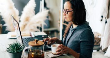 7 Tips on How to Write Good Website Content woman writing on laptop with tea