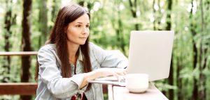 woman working on laptop on porch