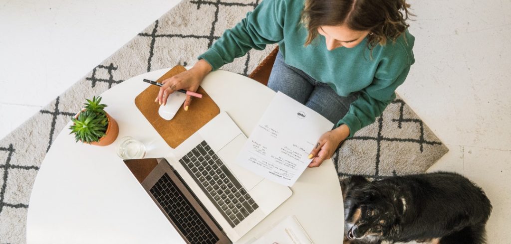 woman working on laptop with dog