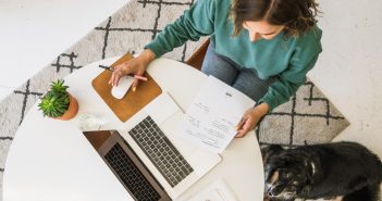 Content Writing as a Career: A Surefire Route to a Steady Writing Income woman working on laptop with dog