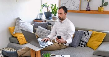 One of the Best Ways to Save Time and Improve Your Efficiency as a Writer: Choosing a Niche man working on computer at home couch