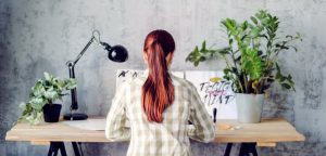 woman on computer writing about her niche