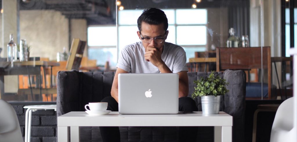 writer staring at computer with analysis paralysis