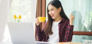 smiling writer on computer happy with success