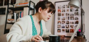 woman writing a call to action on laptop