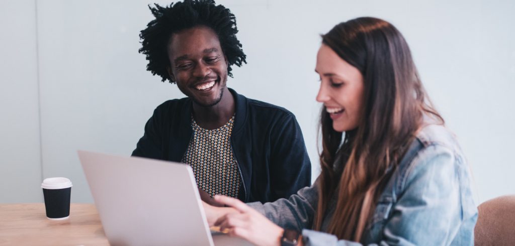 man and woman working on writing samples