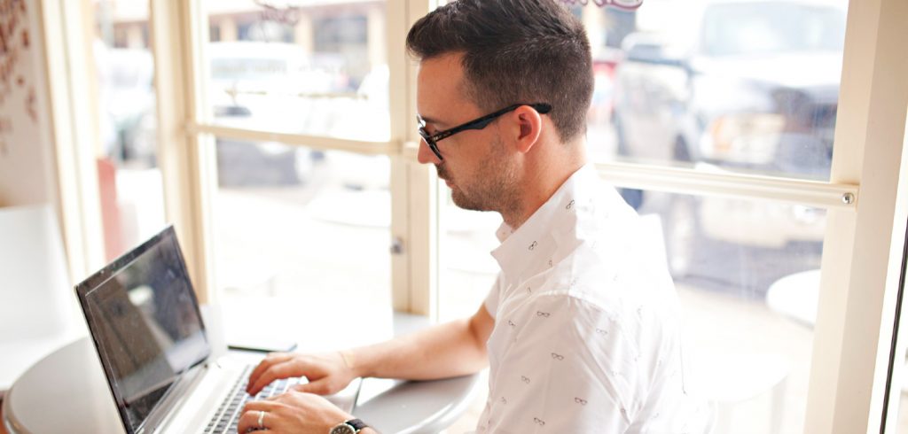 man on laptop writing for B2B industry