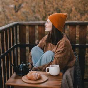 mindful woman on deck with tea