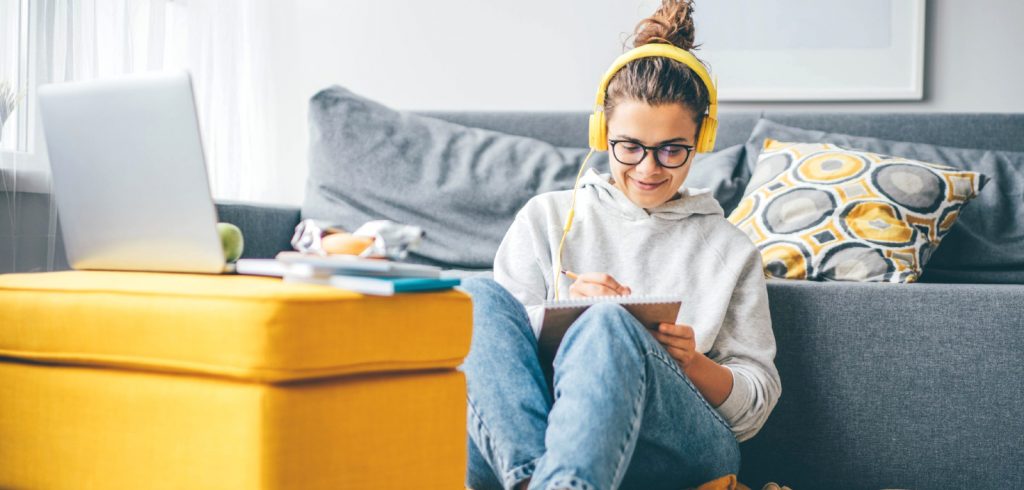 woman using binaural beats on headphones for writing