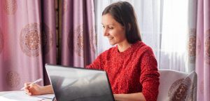woman finding profitable writing opportunities on laptop