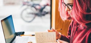 woman working on ghostwriting on laptop computer