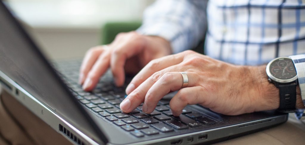 male hands working on laptop