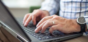 male hands working on laptop